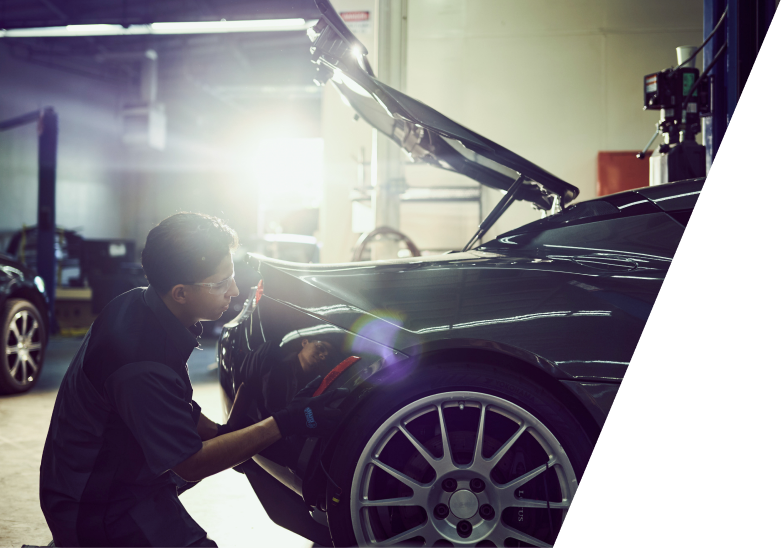 Workshop technician working on car